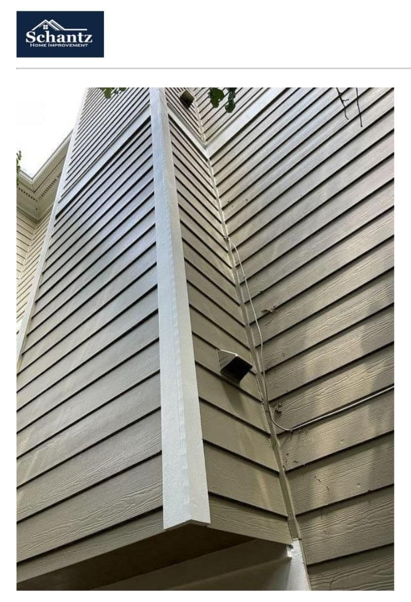 Wooden siding with horizontal panels viewed from below, showing an extended vent or duct structure. The image conveys maintenance or repair needs.