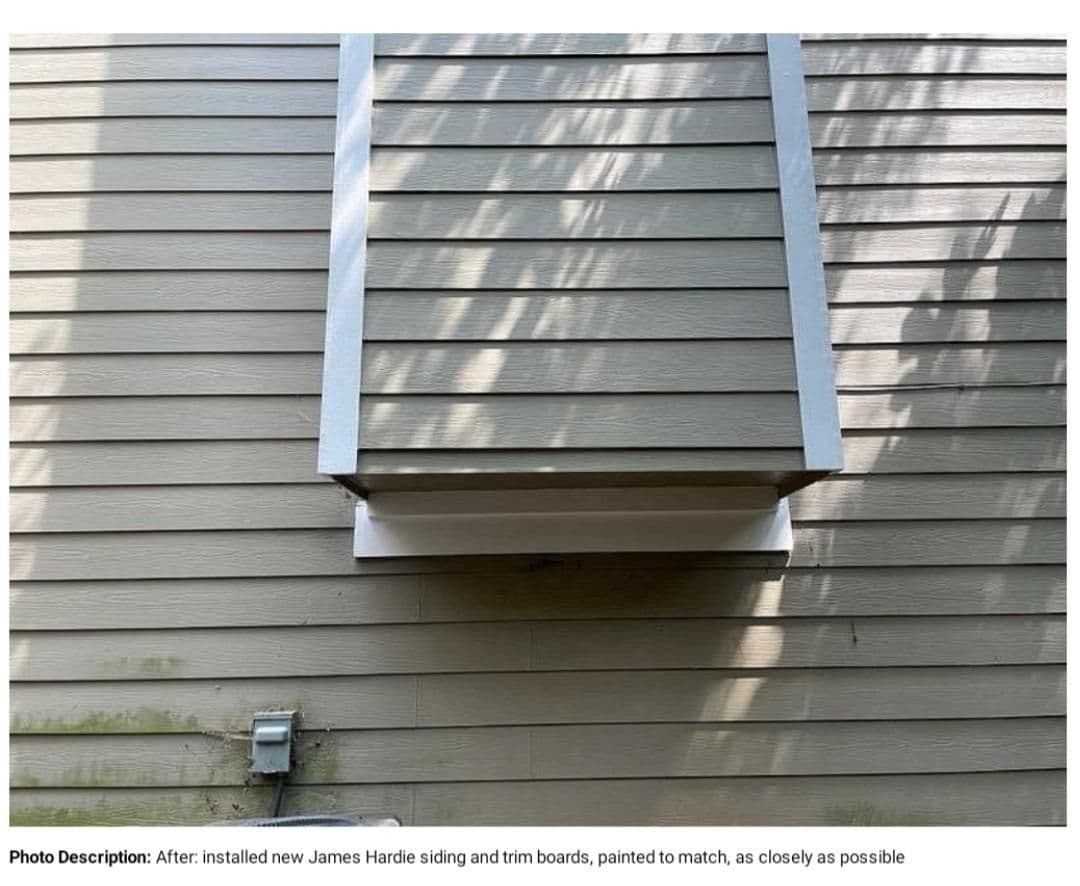 The image shows a section of a house exterior with new James Hardie siding and trim boards. The siding is painted gray, with visible sunlight and shadows.